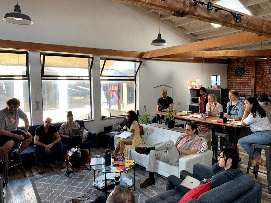 12 Elevate employees at a company meeting in the lounge at the Berkeley office